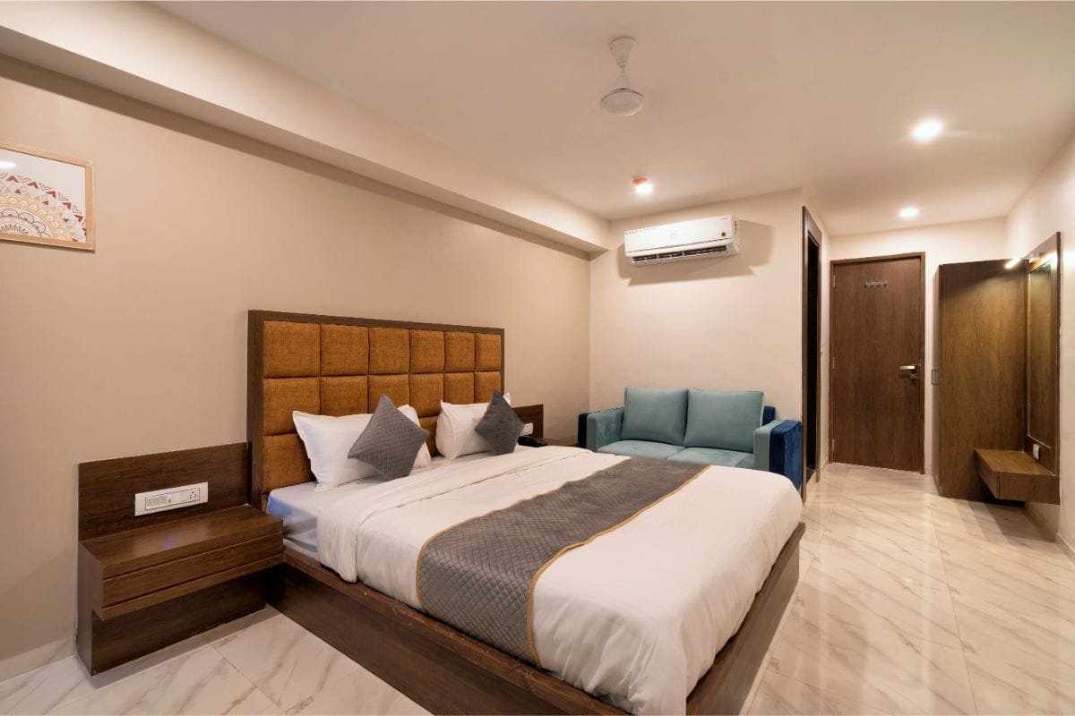 Comfortable guest room with plush bed and sofa seating at Hotel Royal 24