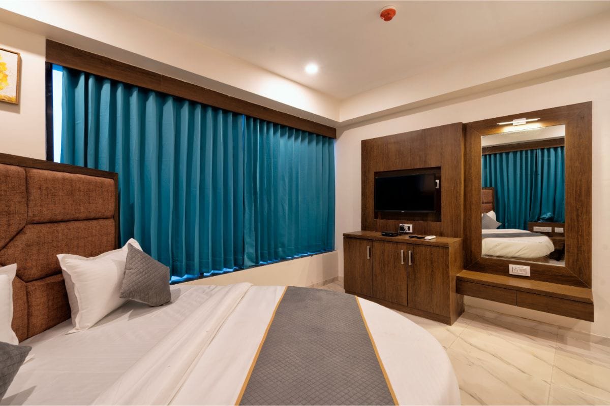 Bedside view with dressing mirror and teal curtains